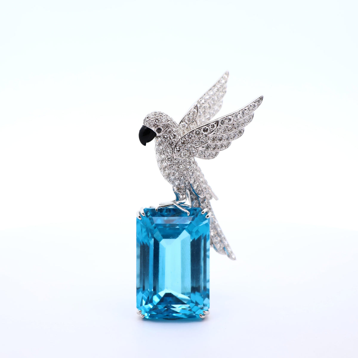 77.38 Carat Blue Topaz Diamond 18K White Gold Bird-on-Rock Brooch