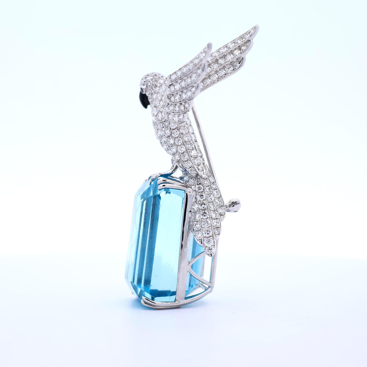 77.38 Carat Blue Topaz Diamond 18K White Gold Bird-on-Rock Brooch