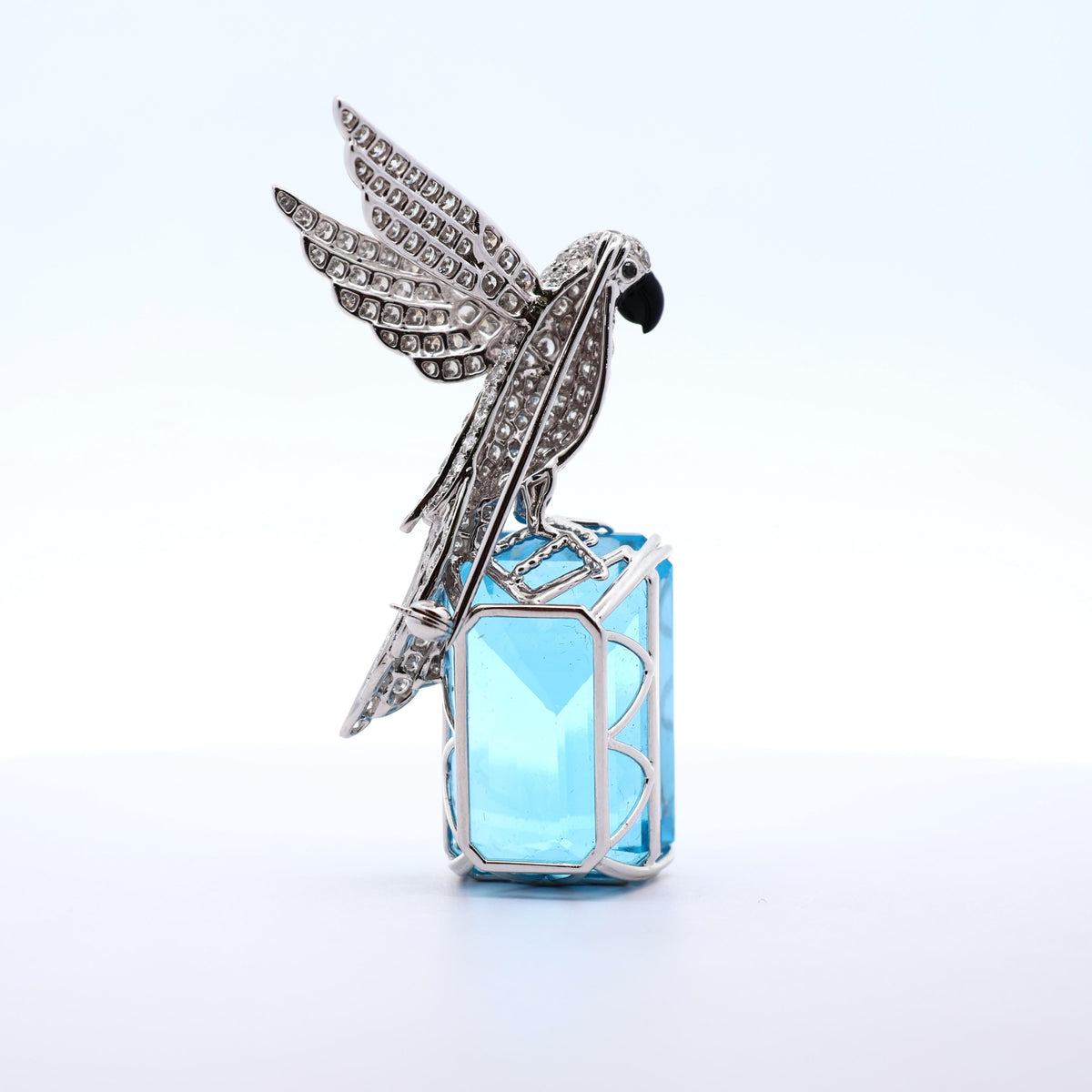 77.38 Carat Blue Topaz Diamond 18K White Gold Bird-on-Rock Brooch