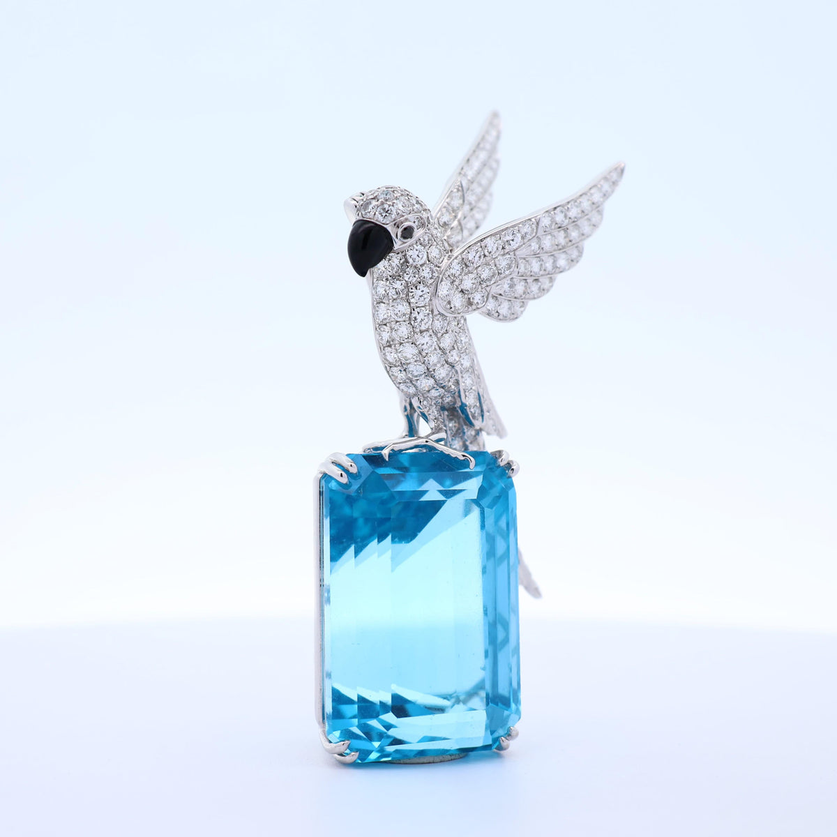 77.38 Carat Blue Topaz Diamond 18K White Gold Bird-on-Rock Brooch