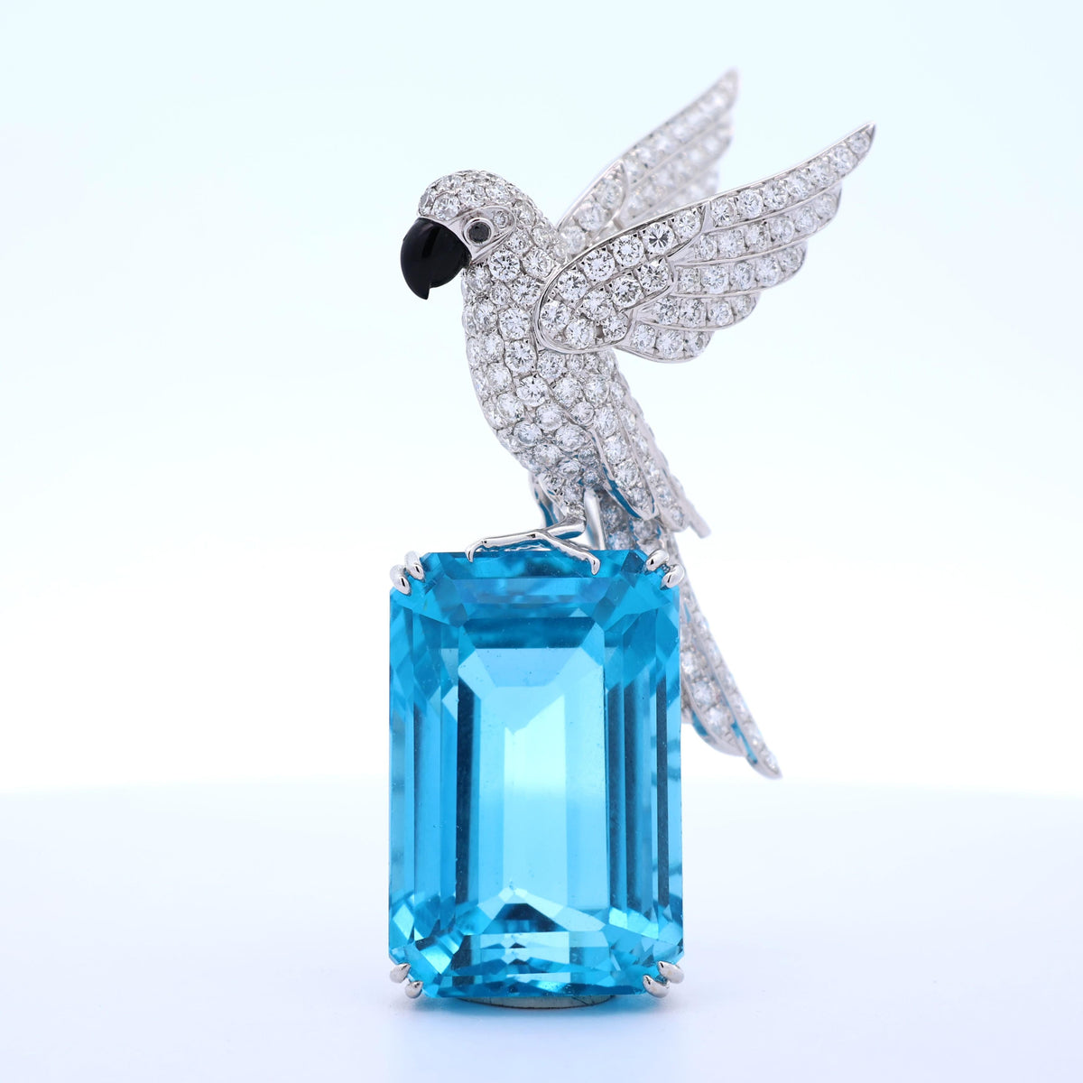 77.38 Carat Blue Topaz Diamond 18K White Gold Bird-on-Rock Brooch